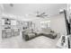 Open-concept living space with modern furnishings, a large sectional sofa, and an adjacent kitchen at 1490 Olive Ct, St Cloud, FL 34771