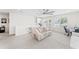 Bright living room with plush carpet, ceiling fan, and large windows at 1490 Olive Ct, St Cloud, FL 34771