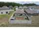 Aerial view of fenced backyard with shed and green space surrounded by homes at 2034 Old Pasture Ln, Lakeland, FL 33801