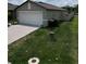 View of the side yard and driveway of a single-story home at 2034 Old Pasture Ln, Lakeland, FL 33801