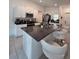 Modern kitchen features granite counters, stainless appliances, and breakfast bar seating at 2034 Old Pasture Ln, Lakeland, FL 33801