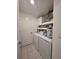 Laundry room with washer, dryer, shelving, and storage cabinets at 2034 Old Pasture Ln, Lakeland, FL 33801