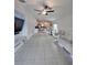 Open concept living area with tile floors connects kitchen to living and dining spaces at 2034 Old Pasture Ln, Lakeland, FL 33801