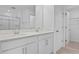 Bathroom featuring double vanity, white cabinets, framed mirrors and walk-in closet at 227 Bull Frog Ln, Umatilla, FL 32784