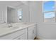 Bathroom with double sink vanity with white cabinets and large mirror at 227 Bull Frog Ln, Umatilla, FL 32784