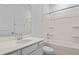 Bathroom with a white vanity, quartz countertop, and shower-tub combo with tile surround at 227 Bull Frog Ln, Umatilla, FL 32784