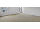 Bright bedroom features plush carpet, white walls and two windows at 227 Bull Frog Ln, Umatilla, FL 32784
