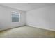 Bright bedroom featuring neutral carpet, white walls and window with a view at 227 Bull Frog Ln, Umatilla, FL 32784
