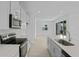 Bright kitchen with white cabinets, stainless steel appliances, quartz countertops, and an open layout at 227 Bull Frog Ln, Umatilla, FL 32784