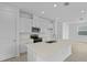 Bright kitchen with white cabinets, stainless steel appliances, quartz countertops, and an island with a sink at 227 Bull Frog Ln, Umatilla, FL 32784