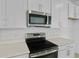 Kitchen showcasing stainless steel appliances and quartz countertops at 227 Bull Frog Ln, Umatilla, FL 32784