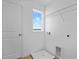 Laundry room area with wash basin, window, utility connections, and storage shelf at 227 Bull Frog Ln, Umatilla, FL 32784