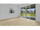 Bright living room featuring sliding glass doors leading to the backyard and tile flooring at 227 Bull Frog Ln, Umatilla, FL 32784