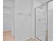 Bathroom shower with glass door, towel bar, and walk-in closet view at 227 Bull Frog Ln, Umatilla, FL 32784