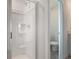 Modern bathroom featuring a glass-enclosed shower with a shower head and tiled floors at 232 Flag Lilly Ln, Umatilla, FL 32784