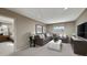 Cozy bonus room with comfortable seating, carpeted flooring and large tv at 232 Flag Lilly Ln, Umatilla, FL 32784