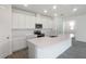 The spacious kitchen offers white cabinetry, stainless steel appliances, and a large island with sink and counterspace at 232 Flag Lilly Ln, Umatilla, FL 32784