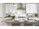 Bright kitchen showcasing white cabinets, stainless appliances, and center island with bar seating at 232 Flag Lilly Ln, Umatilla, FL 32784