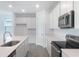 Bright kitchen features white cabinets, stainless steel appliances, and sleek countertops at 232 Flag Lilly Ln, Umatilla, FL 32784