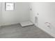 Clean laundry room with gray tile flooring and modern hookups, ready for appliances at 232 Flag Lilly Ln, Umatilla, FL 32784