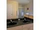 Bathroom featuring double sinks, green marble counters, and a large mirror at 240 Steamboat Blvd, Davenport, FL 33897