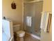 Bathroom features a tiled shower with glass door, toilet, and tub at 240 Steamboat Blvd, Davenport, FL 33897