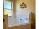 A spacious bathtub with tile surround and fish wall decor at 240 Steamboat Blvd, Davenport, FL 33897
