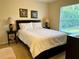 Bedroom featuring a queen bed and two side tables with lamps at 240 Steamboat Blvd, Davenport, FL 33897