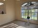 Bright and airy bedroom with neutral carpet, large window, and a decorative glass side table at 240 Steamboat Blvd, Davenport, FL 33897