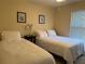 Bright bedroom featuring two twin beds and a nightstand at 240 Steamboat Blvd, Davenport, FL 33897