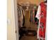 Walk-in closet with clothes on hangers and shelves at 240 Steamboat Blvd, Davenport, FL 33897