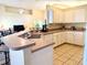 Open kitchen featuring a breakfast bar and white appliances, offering a cozy space at 240 Steamboat Blvd, Davenport, FL 33897