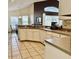 Bright kitchen with white cabinets, a peninsula counter, and tile flooring at 240 Steamboat Blvd, Davenport, FL 33897