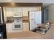 Functional kitchen with white appliances, double basin sink, and ample counter space at 240 Steamboat Blvd, Davenport, FL 33897