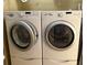 The laundry room features a white front load washer and dryer at 240 Steamboat Blvd, Davenport, FL 33897