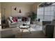 Cozy living room featuring neutral tones, comfortable seating, and large window for natural light at 240 Steamboat Blvd, Davenport, FL 33897