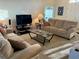 Spacious living room with neutral decor, carpet flooring, and comfortable seating arrangement at 240 Steamboat Blvd, Davenport, FL 33897