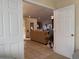 Open-concept living space with tile flooring leading to carpeted living room with comfortable seating at 240 Steamboat Blvd, Davenport, FL 33897