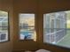 View of screened pool and lanai from room with three large windows at 240 Steamboat Blvd, Davenport, FL 33897