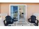 View from balcony with outdoor seating, sliding glass doors to bedroom, and bright, natural light at 2438 Sweetwater Club Cir # 50, Kissimmee, FL 34746