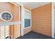 Cozy outdoor balcony featuring peach siding, white railings, and unique round and square windows at 2438 Sweetwater Club Cir # 50, Kissimmee, FL 34746