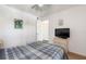 Cozy bedroom with ceiling fan, carpet, and a mounted TV on a dresser at 2438 Sweetwater Club Cir # 50, Kissimmee, FL 34746