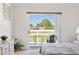 Bright bedroom with sliding glass doors to a patio, dresser, and carpet at 2438 Sweetwater Club Cir # 50, Kissimmee, FL 34746