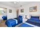 Charming bedroom with twin beds, ceiling fan, and mirror closet doors at 2438 Sweetwater Club Cir # 50, Kissimmee, FL 34746