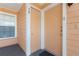 Inviting condo entrance featuring a gray porch, two peach doors, and a side window for natural light at 2438 Sweetwater Club Cir # 50, Kissimmee, FL 34746