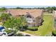 Inviting exterior view of a two-story condo with a well-maintained lawn and mature trees at 2438 Sweetwater Club Cir # 50, Kissimmee, FL 34746