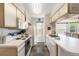 Efficient kitchen layout with white appliances, ample counter space, and a view into the adjacent dining area at 2438 Sweetwater Club Cir # 50, Kissimmee, FL 34746