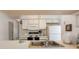 Bright kitchen featuring white cabinets, modern appliances, and a double sink, perfect for everyday use at 2438 Sweetwater Club Cir # 50, Kissimmee, FL 34746