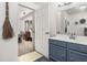 Bathroom featuring a white door leading into the bedroom, and blue vanity at 2620 Lodi Cir # 103, Kissimmee, FL 34746