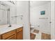 Bright bathroom featuring a wooden cabinet, and a clean white toilet at 2620 Lodi Cir # 103, Kissimmee, FL 34746